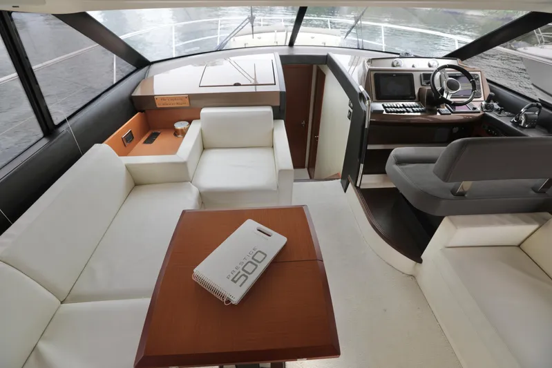 Perseus Yacht Photos Pics Luxurious interior of a 2013 Prestige 500 yacht with modern seating and helm.