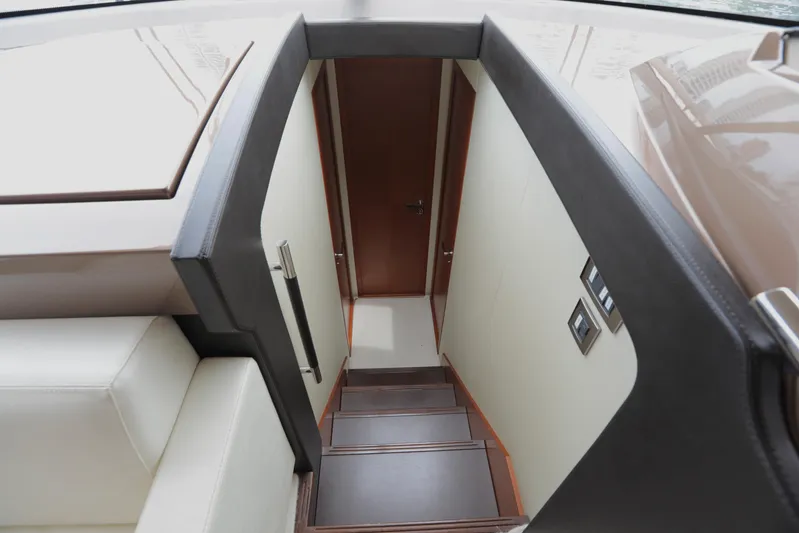 Perseus Yacht Photos Pics Interior stairs of a 2013 Prestige 500 yacht leading to lower deck.