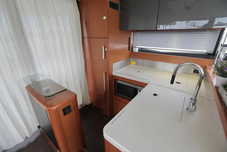 Perseus Yacht Photos Pics Modern kitchen area in a 2013 Prestige 500 yacht with sleek cabinetry and appliances.