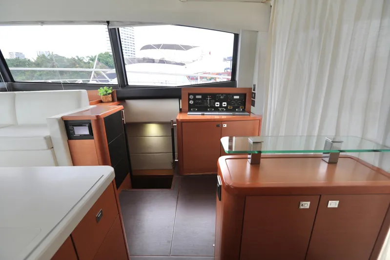 Perseus Yacht Photos Pics Interior of a 2013 Prestige 500 yacht with modern wooden cabinetry and large windows.