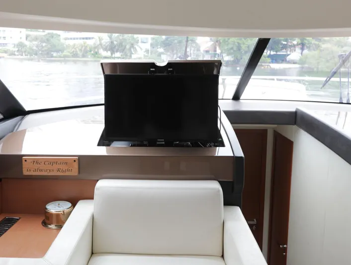 Perseus Yacht Photos Pics Interior of a 2013 Prestige 500 yacht with a TV and captain's chair.