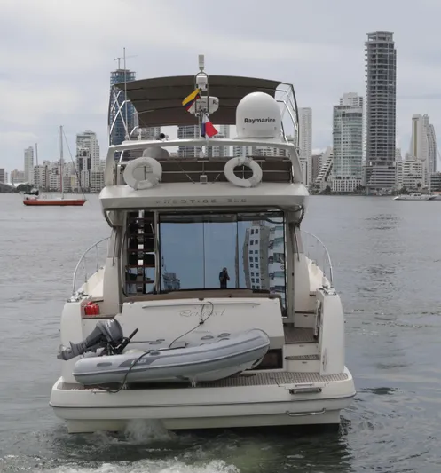 Perseus Yacht Photos Pics Prestige 500 yacht, 2013 model, cruising in urban waters with city skyline in the background.