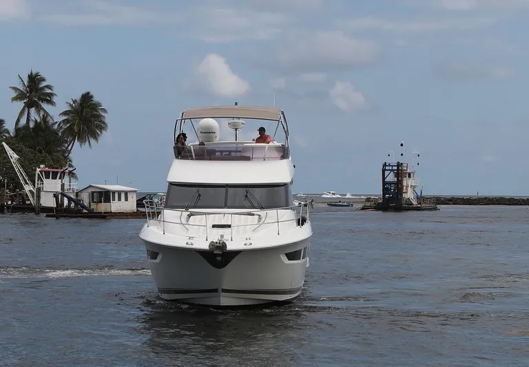 Perseus Yacht Photos Pics 2013 Prestige 500 yacht cruising in a tropical harbor.