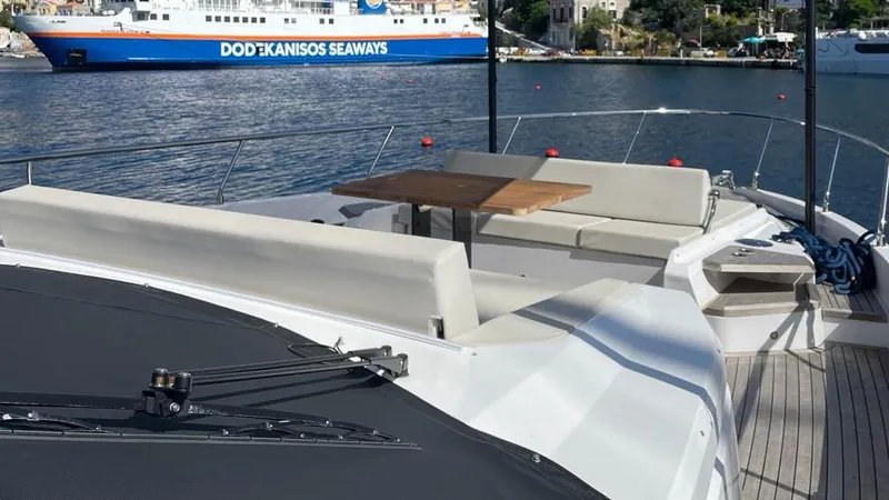  Yacht Photos Pics 2023 Ferretti Yachts 720 with spacious deck seating and table, docked near a ferry.