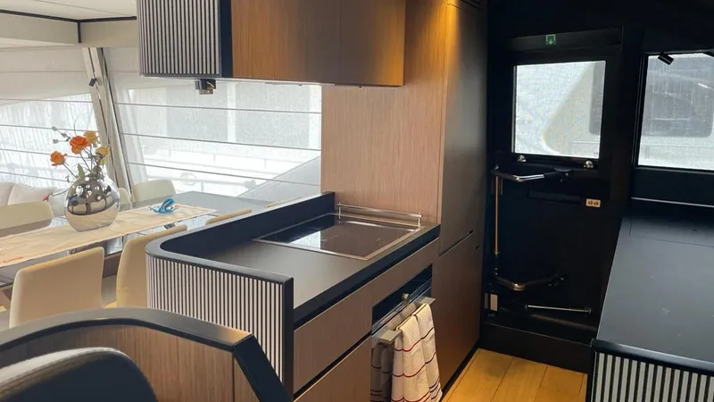  Yacht Photos Pics Luxurious interior of 2023 Ferretti Yachts 720, featuring modern kitchen and dining area.