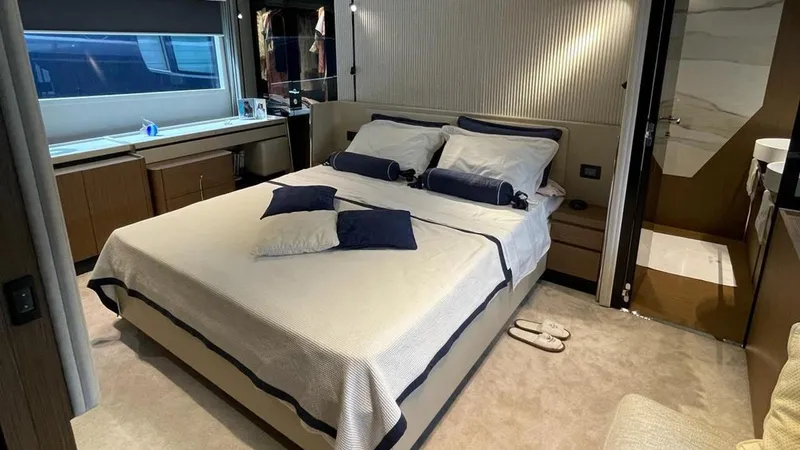  Yacht Photos Pics Luxurious bedroom interior of 2023 Ferretti Yachts 720, featuring elegant bedding and modern design.