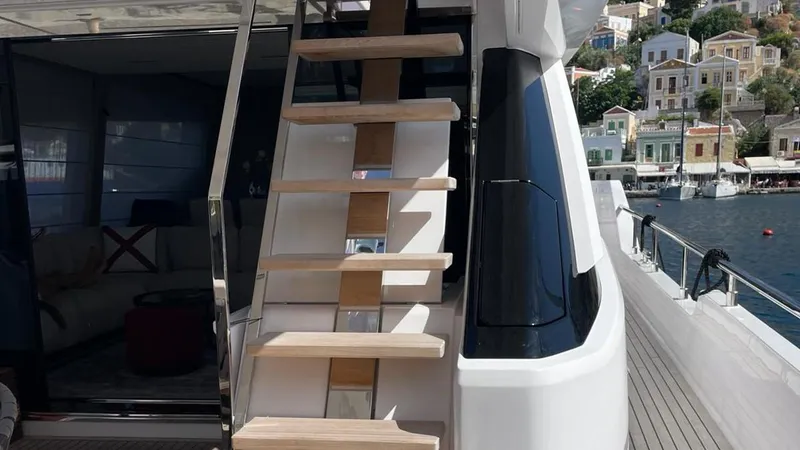  Yacht Photos Pics 2023 Ferretti Yachts 720, luxury yacht stairs and deck with scenic waterfront view.