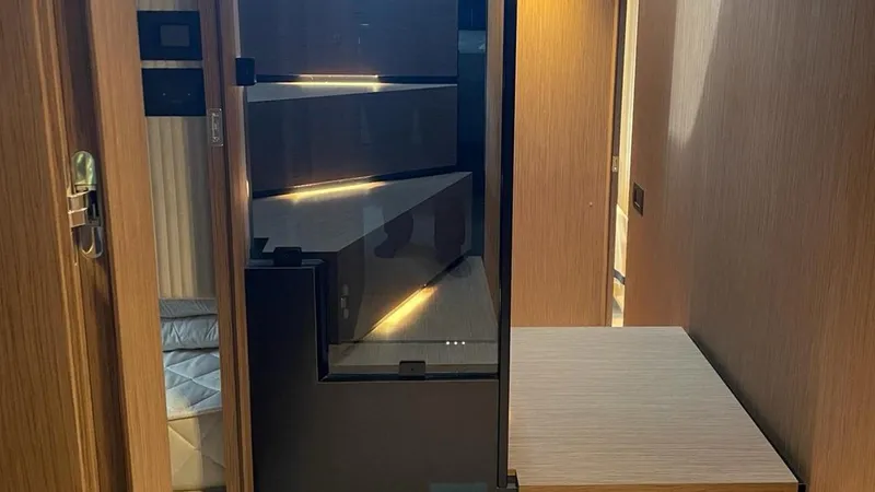  Yacht Photos Pics Modern interior of 2023 Ferretti Yachts 720 with sleek wood finishes and ambient lighting.