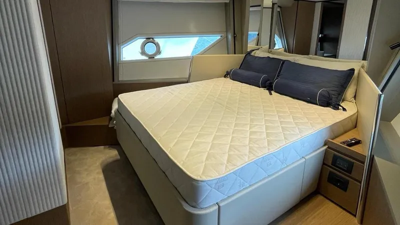  Yacht Photos Pics Luxurious bedroom interior of 2023 Ferretti Yachts 720 with elegant bedding and modern design.