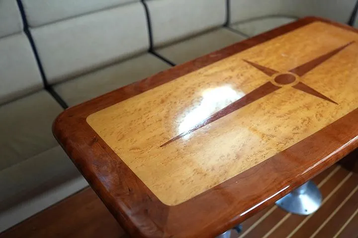 Melissa Marie 2 Yacht Photos Pics Polished wooden table with compass design in 2006 Sabre 38 Hardtop Express interior.