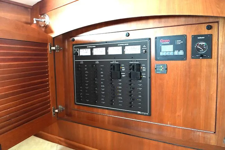 Melissa Marie 2 Yacht Photos Pics Electrical control panel inside 2006 Sabre 38 Hardtop Express yacht, featuring wooden cabinetry.