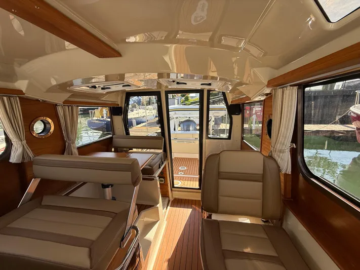  Yacht Photos Pics Interior of 2021 Ranger Tugs R-27 boat, featuring elegant seating and wood accents.