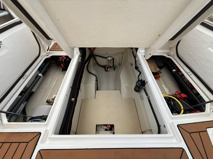  Yacht Photos Pics 2021 Ranger Tugs R-27 engine compartment with open hatch, showcasing internal components and wiring.