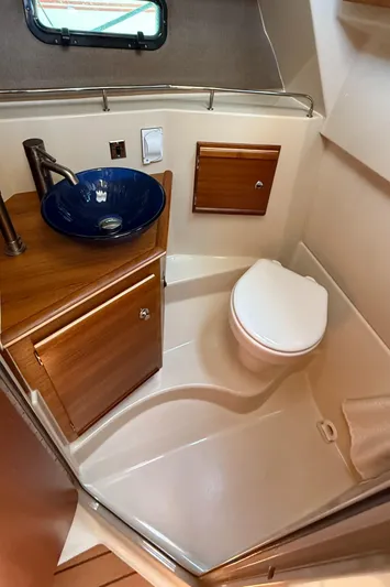  Yacht Photos Pics 2021 Ranger Tugs R-27 bathroom with modern sink and toilet, compact and stylish design.