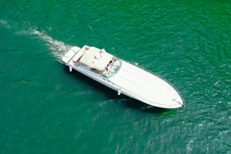  Yacht Photos Pics Aerial view of 1997 Sea Ray 630 Super Sun Sport yacht cruising on turquoise water.