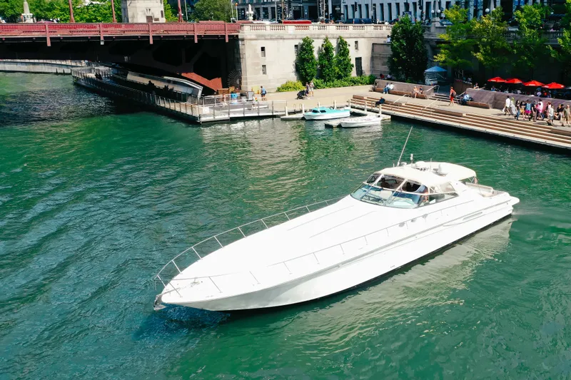  Yacht Photos Pics 1997 Sea Ray 630 Super Sun Sport yacht cruising on a scenic river near a bridge.