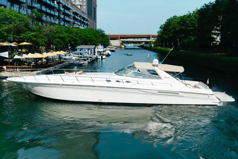  Yacht Photos Pics 1997 Sea Ray 630 Super Sun Sport yacht cruising in a scenic canal.
