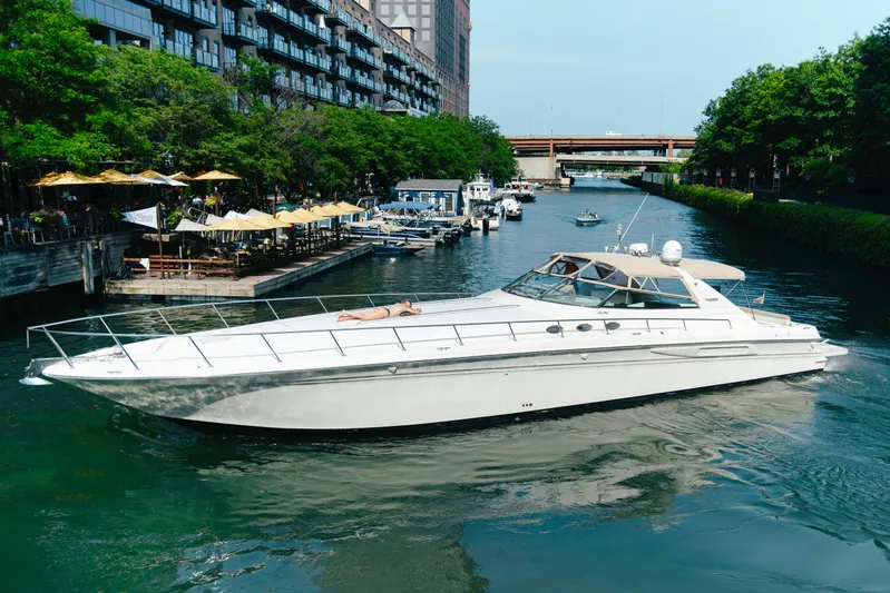  Yacht Photos Pics 1997 Sea Ray 630 Super Sun Sport yacht cruising in a scenic urban canal.