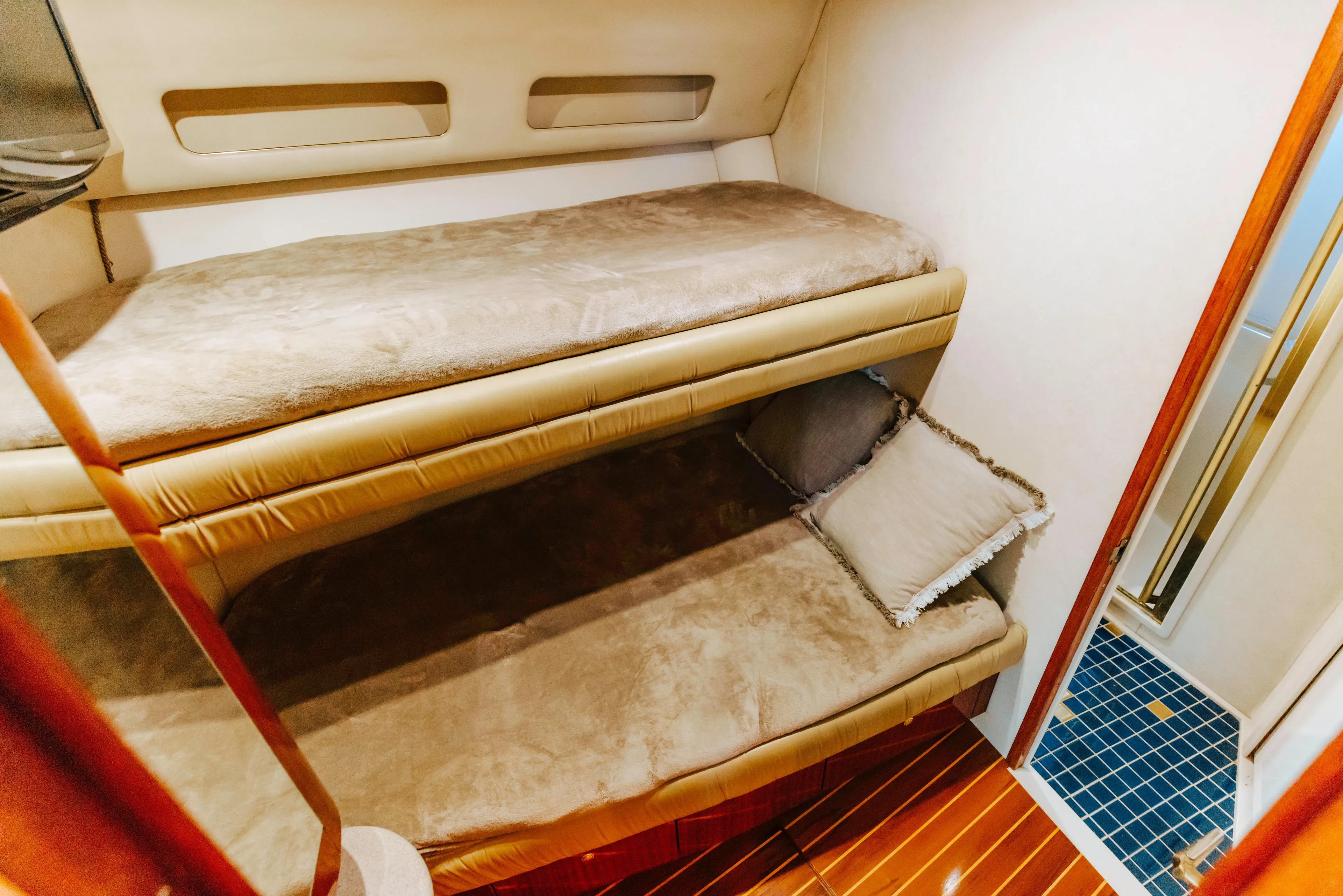  Yacht Photos Pics Interior of 1997 Sea Ray 630 Super Sun Sport with cozy bunk beds and wooden flooring.