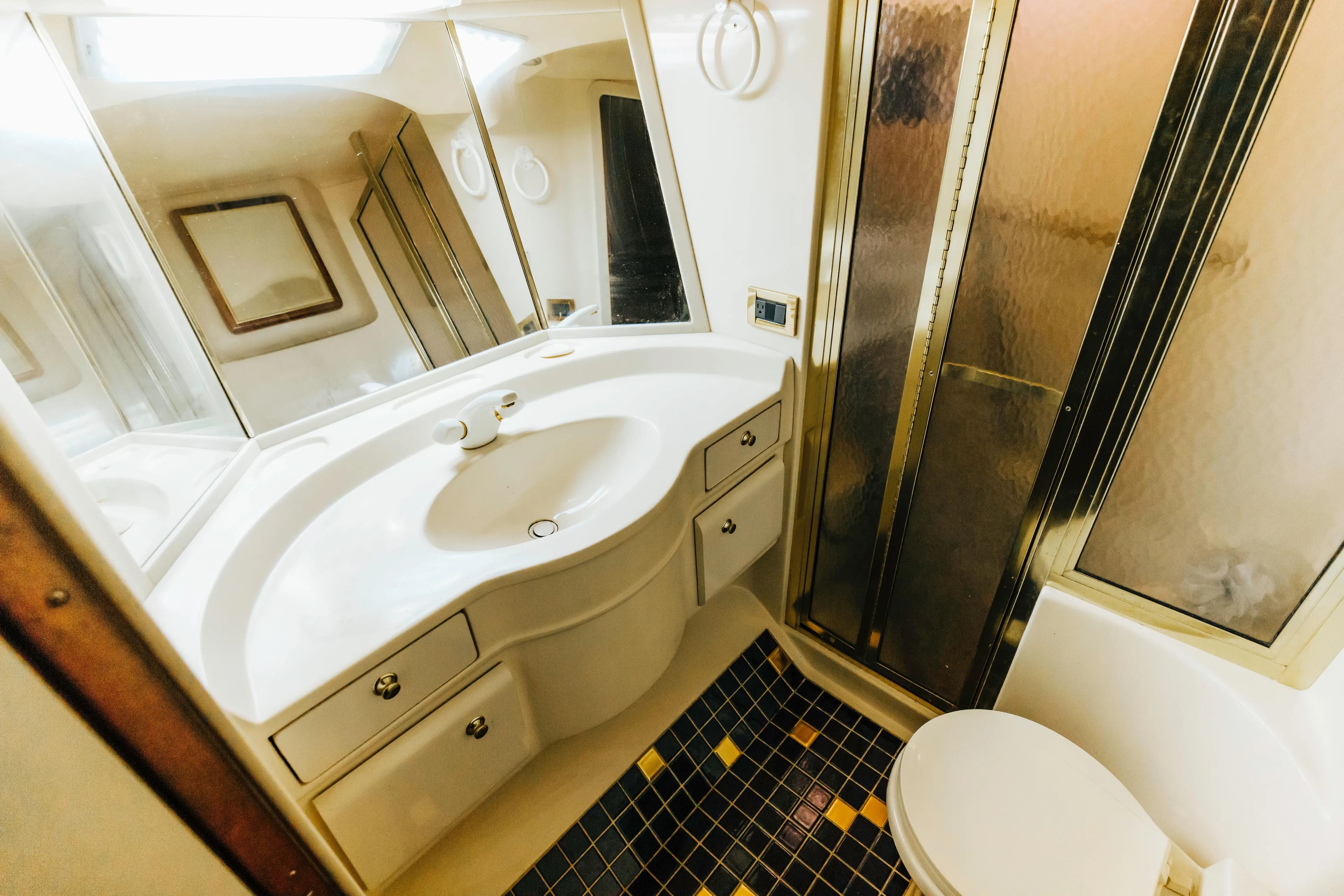  Yacht Photos Pics Bathroom interior of 1997 Sea Ray 630 Super Sun Sport yacht, featuring sink and shower.