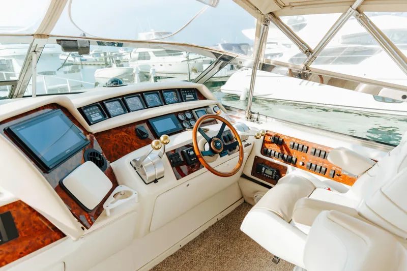  Yacht Photos Pics Luxurious 1997 Sea Ray 630 Super Sun Sport yacht cockpit with modern controls and wood accents.