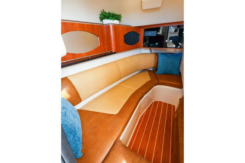 4850 Jg Yacht Photos Pics 2015 Grady White 335 Freedom cabin interior with cushioned seating and wooden accents.