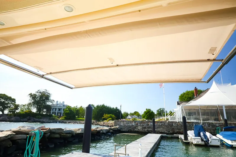 4850 Jg Yacht Photos Pics 2015 Grady White 335 Freedom boat with extended canopy at a scenic dock.