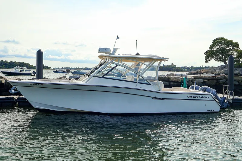 4850 Jg Yacht Photos Pics 2015 Grady-White 335 Freedom boat docked by rocky shoreline.