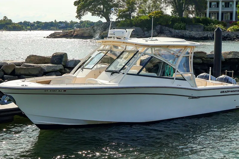 4850 Jg Yacht Photos Pics 2015 Grady White 335 Freedom boat docked by rocky shoreline.