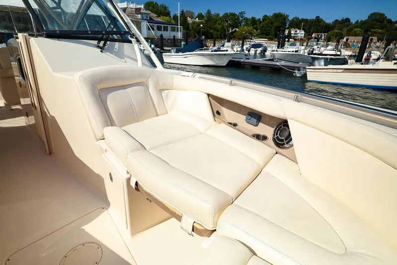 4850 Jg Yacht Photos Pics 2015 Grady White 335 Freedom boat interior with beige seating, docked at marina.