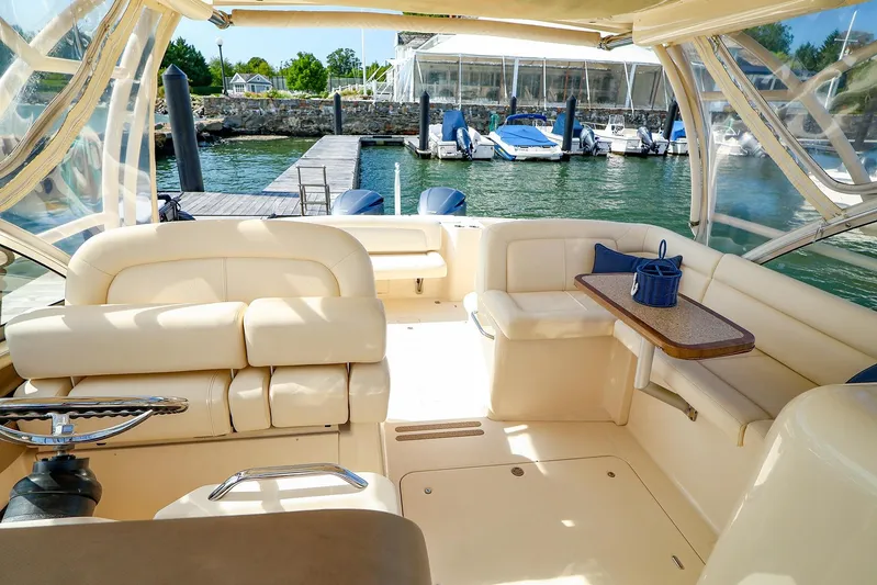 4850 Jg Yacht Photos Pics 2015 Grady White 335 Freedom boat interior with seating and table, docked at marina.