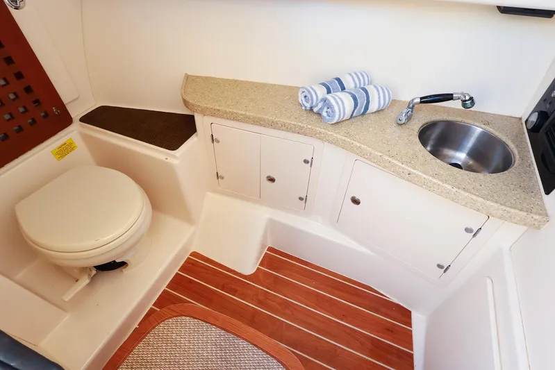 4850 Jg Yacht Photos Pics 2015 Grady White 335 Freedom boat bathroom with sink, toilet, and wooden flooring.