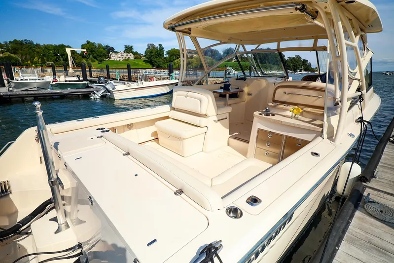 4850 Jg Yacht Photos Pics 2015 Grady White 335 Freedom boat docked, featuring spacious seating and elegant design.