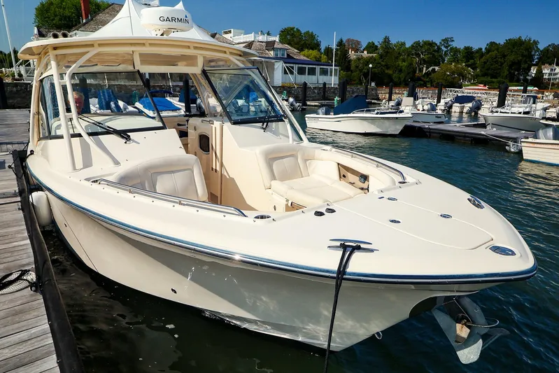 4850 Jg Yacht Photos Pics 2015 Grady White 335 Freedom boat docked at marina, featuring spacious seating and sleek design.