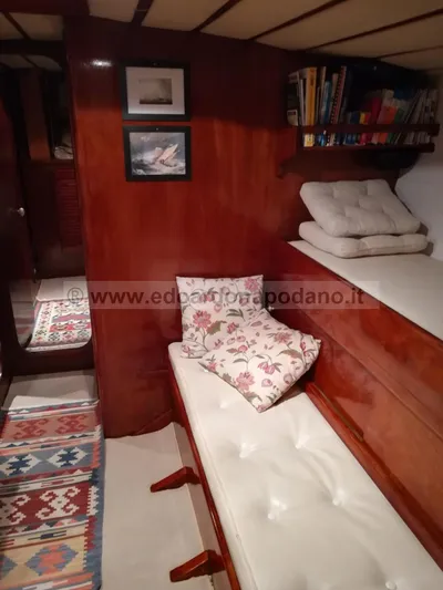  Yacht Photos Pics Interior of 1984 Classic Sciarrelli yacht with wooden paneling and cozy seating area.