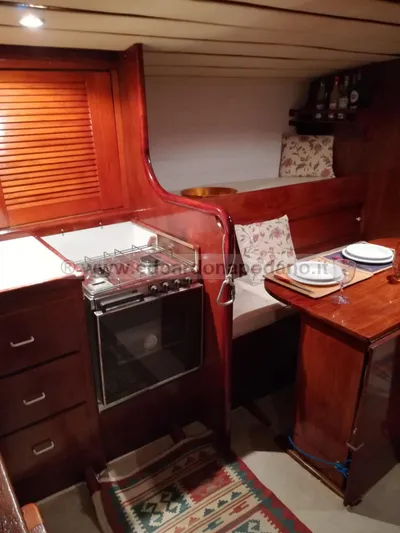  Yacht Photos Pics Interior of 1984 Classic Sciarrelli yacht with wooden cabinetry and dining area.