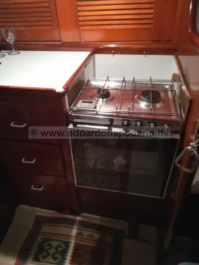  Yacht Photos Pics 1984 Classic Sciarrelli yacht kitchen with stove, wooden cabinets, and countertop.