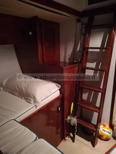  Yacht Photos Pics Interior of 1984 Classic Sciarrelli yacht with wooden ladder and cozy bedding.