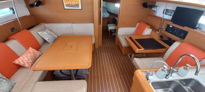 Alma Del Mar Yacht Photos Pics Interior of 2014 Jeanneau Sun Odyssey 469 yacht with modern seating and kitchen area.