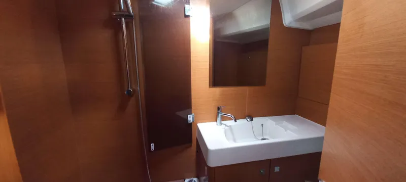 Alma Del Mar Yacht Photos Pics Bathroom interior of 2014 Jeanneau Sun Odyssey 469 yacht with modern sink and shower.