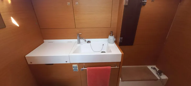 Alma Del Mar Yacht Photos Pics Bathroom interior of 2014 Jeanneau Sun Odyssey 469 yacht, featuring sink and shower area.