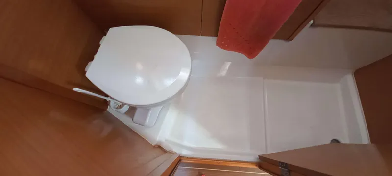 Alma Del Mar Yacht Photos Pics Bathroom interior of 2014 Jeanneau Sun Odyssey 469 yacht, featuring a compact toilet.