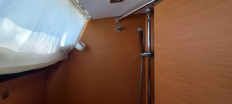 Alma Del Mar Yacht Photos Pics Interior shower area of 2014 Jeanneau Sun Odyssey 469 yacht with wooden paneling.