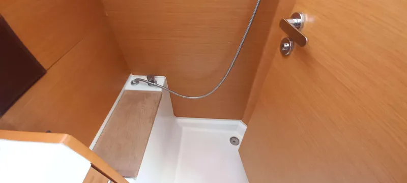 Alma Del Mar Yacht Photos Pics Shower area in 2014 Jeanneau Sun Odyssey 469 yacht with wooden paneling.