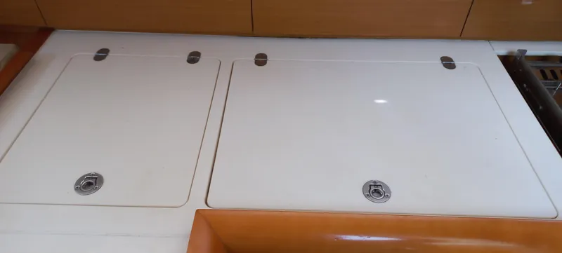 Alma Del Mar Yacht Photos Pics Interior view of 2014 Jeanneau Sun Odyssey 469 yacht kitchen area with storage compartments.