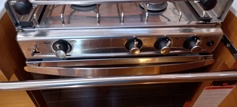 Alma Del Mar Yacht Photos Pics Stainless steel stove and oven in 2014 Jeanneau Sun Odyssey 469 yacht kitchen.