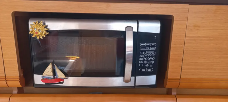 Alma Del Mar Yacht Photos Pics Microwave with nautical magnets in Jeanneau Sun Odyssey 469, 2014 model.