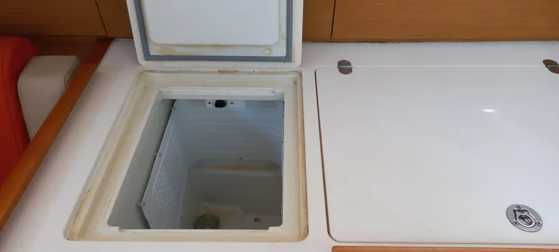 Alma Del Mar Yacht Photos Pics 2014 Jeanneau Sun Odyssey 469 yacht interior with open storage compartment.