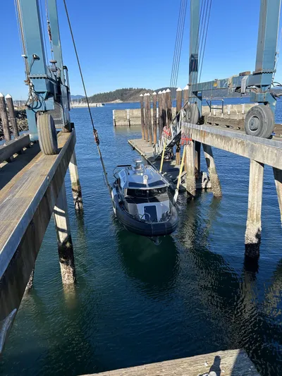  Yacht Photos Pics 2021 Life Proof 25 Full Cabin boat being lifted at a dockside facility.