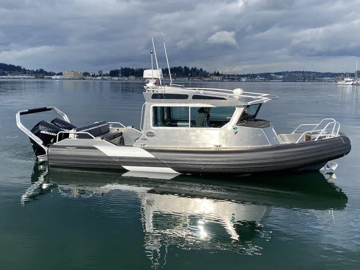  Yacht Photos Pics 2021 Life Proof 25 Full Cabin boat on calm water under cloudy skies.